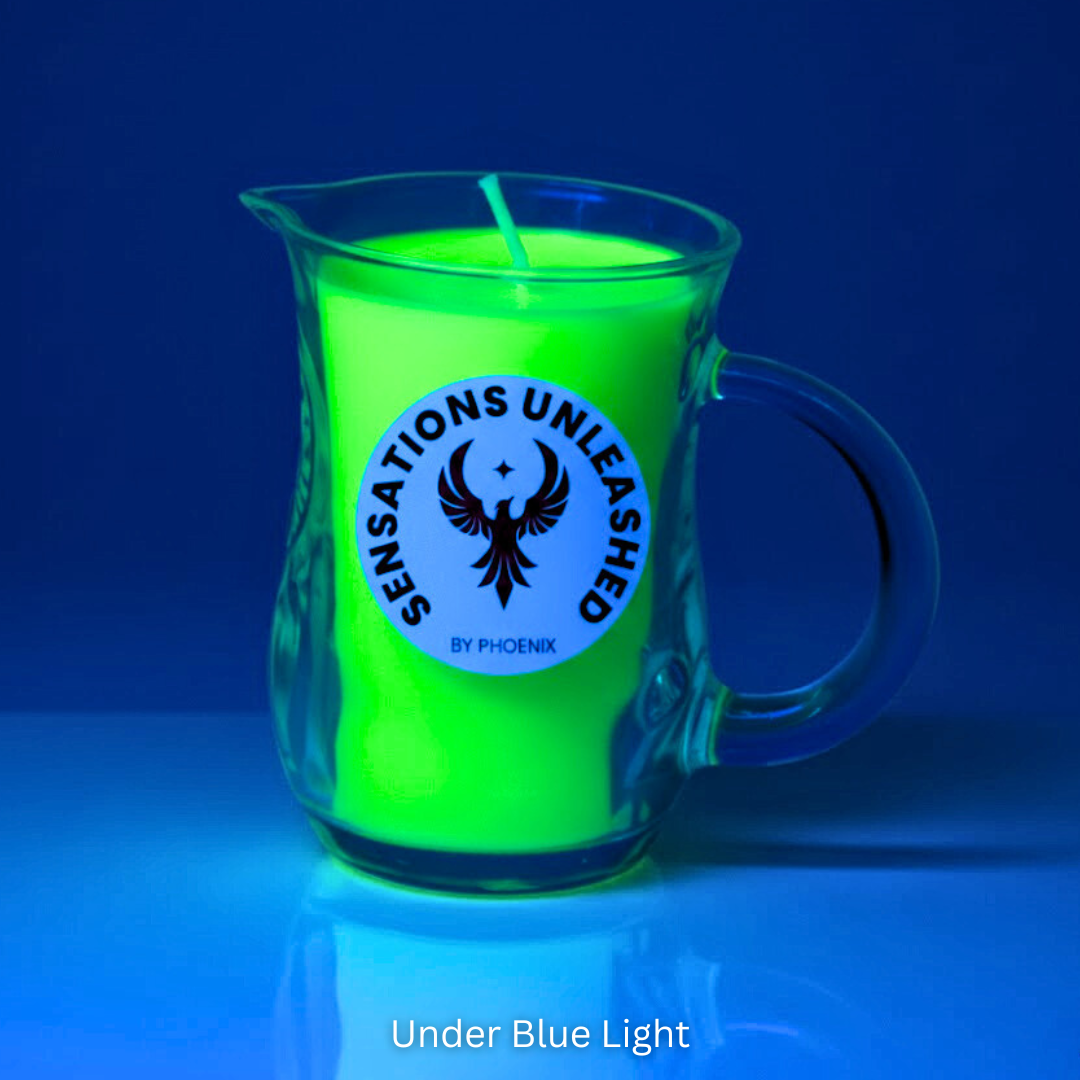 Glowing green candle in a glass jar with 'Sensations Unleashed by Phoenix' logo under blue light.
Sensations Unleashed BDSM UV Wax Play Glass Jar Candle with Handle In India- Single Colour